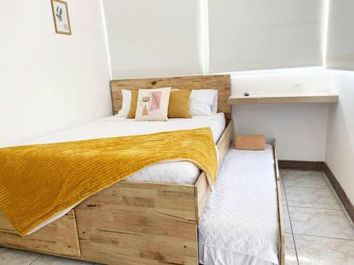 a small bedroom with a wooden bed and a shelf at Detailed and Modern Apartment D in Guatemala