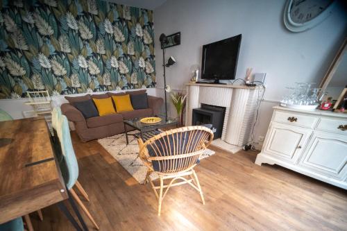 a living room with a couch and a fireplace at *OKALEE* in Dinan