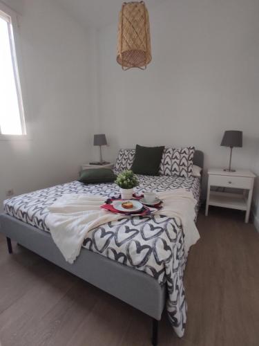 a bedroom with a bed with a table on it at Precioso apartamento en Puente Vallecas, Madrid. in Madrid