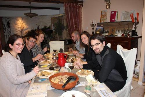 a group of people sitting at a table eating food at L'Oustal de l'Annetta Chambres et Tables d'Hôtes in Comus