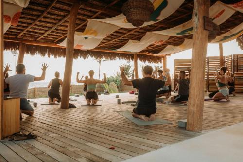 a group of people doing yoga in a pavilion at Selina Poc Na Isla Mujeres in Isla Mujeres