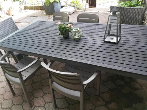 a wooden table with chairs and a plant on it at Vakantiehuis Ardennen les Forges, Chevron in Theux