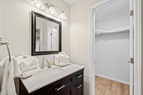 a bathroom with a sink and a mirror at Lagoon Retreat in Pensacola