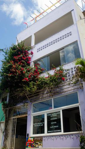 a building with flowers on the side of it at Pousada e Hostel Chez Marianne in Salvador