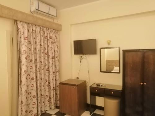 a hotel room with a sink and a mirror at Royal City Hotel in Hurghada