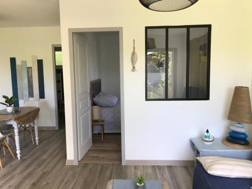 a living room with a mirror and a table at Charmante Cabane Bois in Gujan-Mestras