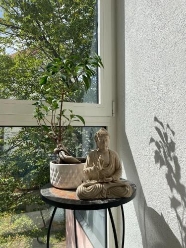 a statue sitting on a table next to a window at Hotel Berg in Stuttgart
