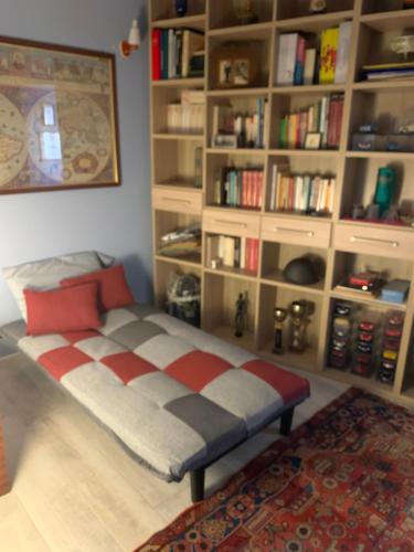 a bed in a room with a book shelf at Confortevole casa di montagna- La Campana in San Marcello Pistoiese