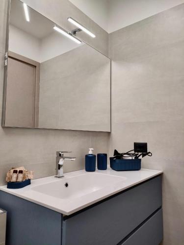 a bathroom with a sink and a mirror at La Petite Maison in Pietrapertosa