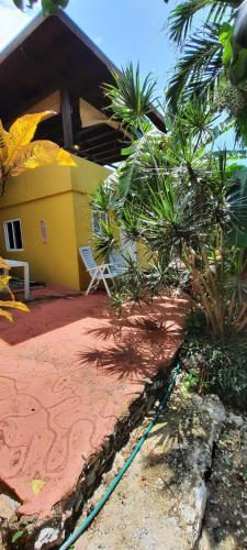 a yellow house with a hose in front of it at Studio 5 min from the beach in Kas Chikitu