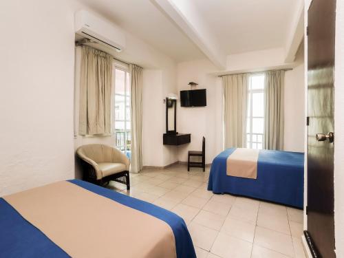 Postel nebo postele na pokoji v ubytování Hotel Trianon