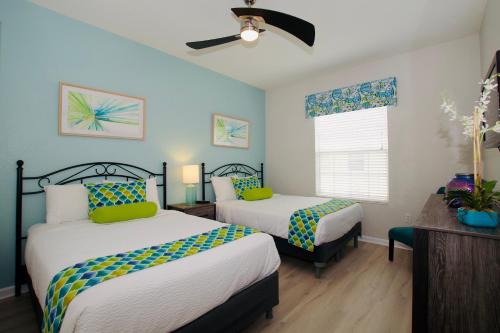 a bedroom with two beds and a window at Vista Cay Standard 2 bedroom condo (#3102) in Orlando