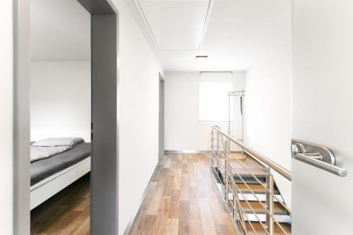 a bedroom with a staircase leading to a bed at Ferienwohnung Spreeblick in Alter Graben