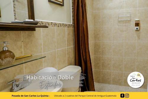 a bathroom with a toilet and a shower at Posada de San Carlos La Quinta in Antigua Guatemala