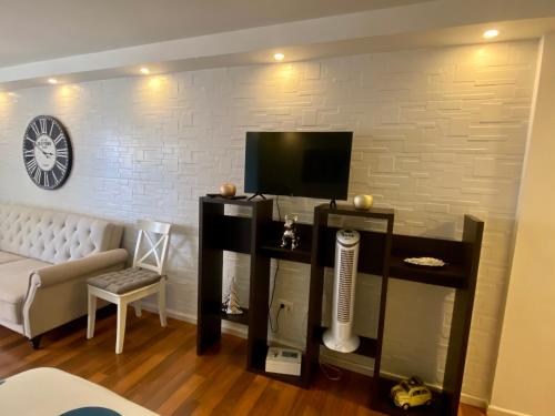 a living room with a television and a couch at LOFT vistas playa jardin in Puerto de la Cruz