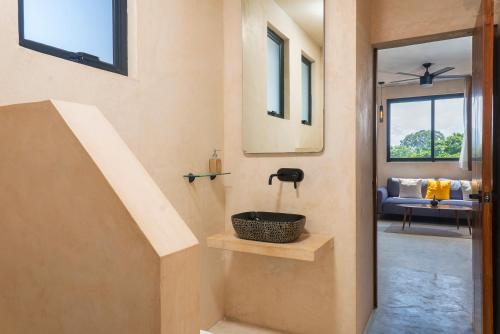 a room with a staircase with a basket on a shelf at UJO Condo Boutique in Tulum