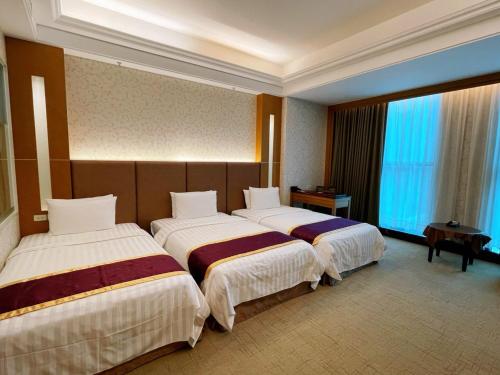 Postel nebo postele na pokoji v ubytování Happiness Inn Hotel