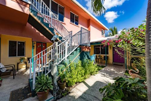 a colorful house with a staircase and plants at The Desoto - Oceanview Inn in Hollywood