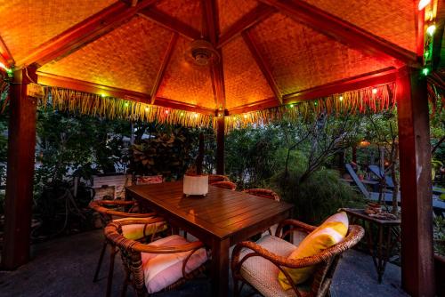 a wooden table and chairs on a patio at The Desoto - Oceanview Inn in Hollywood