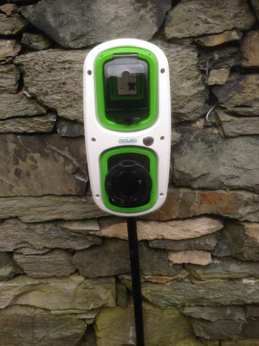 a green and white camera attached to a stone wall at Kirkwood Guest House in Windermere