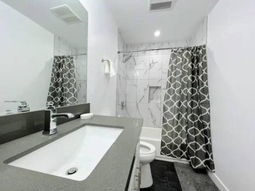 a bathroom with a sink and a toilet and a shower at 4BR Townhouse in KoreaTown in Los Angeles