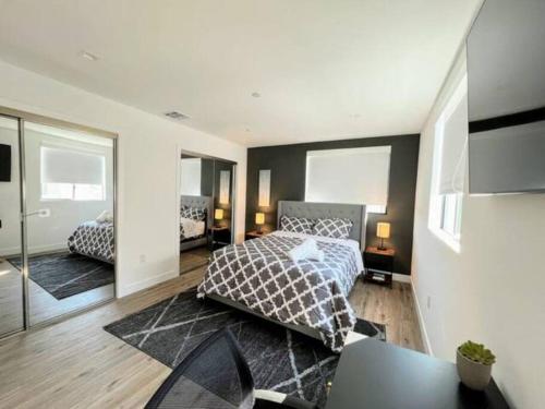 a bedroom with a bed and a table and a mirror at 4BR Townhouse in KoreaTown in Los Angeles