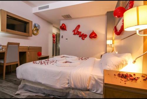 a bedroom with a bed with red decorations on the wall at El Ghanami Hotel in Alger
