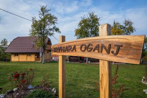 a wooden sign that reads camparia olean in a yard at Brvnara Oganj in Čajetina