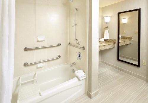 a bathroom with a tub and a sink at Trellis Lake Pointe in Charlotte