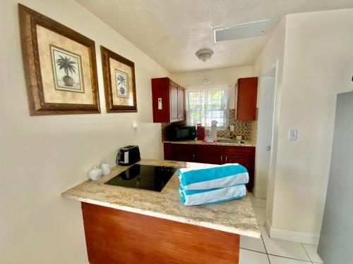 a kitchen with a sink and a counter top at Lido Sunshine L, Steps to Lido Beach in Sarasota