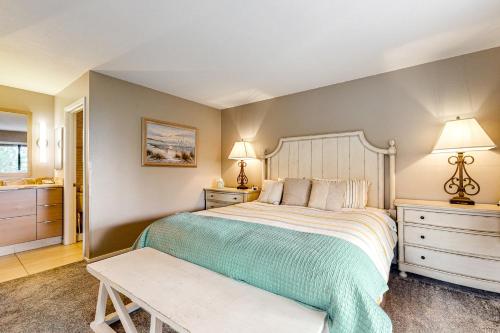 a bedroom with a bed and two night stands and two lamps at Idyllic Ocean-View Oasis in Watsonville