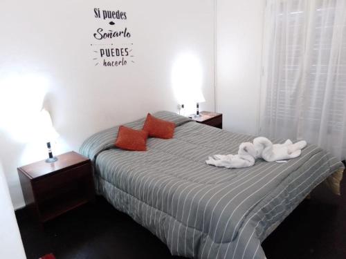 a bedroom with a bed with two animals on it at Hotel Astro in Mar del Plata
