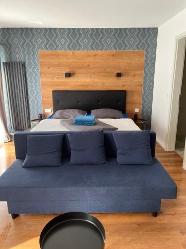 a bedroom with a large bed with a large headboard at Gasthaus am Henriettenhof in Grömitz