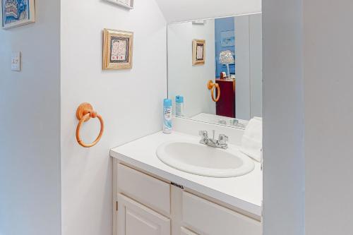 a white bathroom with a sink and a mirror at Walk to the Lakes in Ludlow
