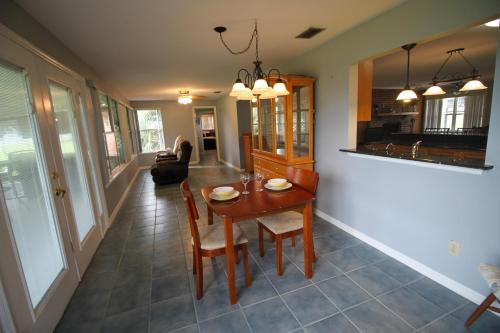 a dining room and living room with a table and chairs at 15 Minutes to the Gulf of Mexico! Beautiful home on Lake Rousseau in Dunnellon