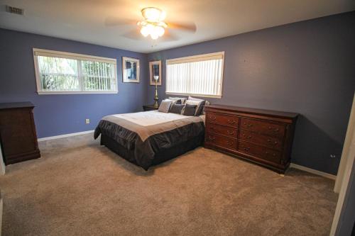 a bedroom with a bed and a ceiling fan at 15 Minutes to the Gulf of Mexico! Beautiful home on Lake Rousseau in Dunnellon