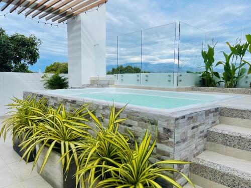 a swimming pool in a house with plants at HOTEL PROVINCIA PLAZA in San Juan del Cesar
