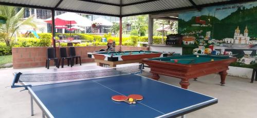 a ping pong table in a room with two pool tables at Hotel & restaurante campestre la siria in San Juan de Rioseco 