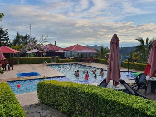 a group of people in the swimming pool at a resort at Hotel & restaurante campestre la siria in San Juan de Rioseco 