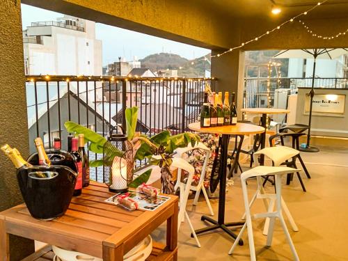 a table and chairs on a balcony with a view at Mange Tak Resort Onomichi in Onomichi