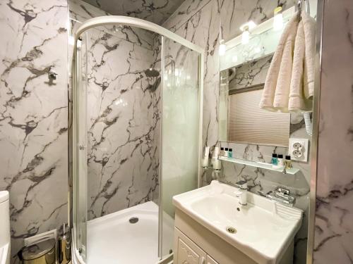 a bathroom with a shower and a sink and a toilet at Medina Hotel Samarkand in Samarkand