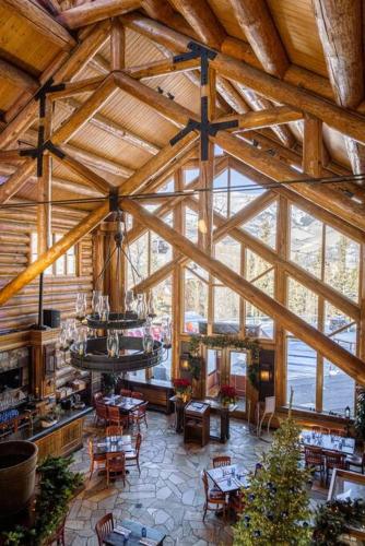 a large wooden building with tables and chairs in it at Blue Collar Boutique: Affordable Adventure in Telluride