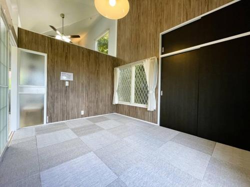 Camera con porta nera e pavimento piastrellato. di Tsunore51 a Kashima