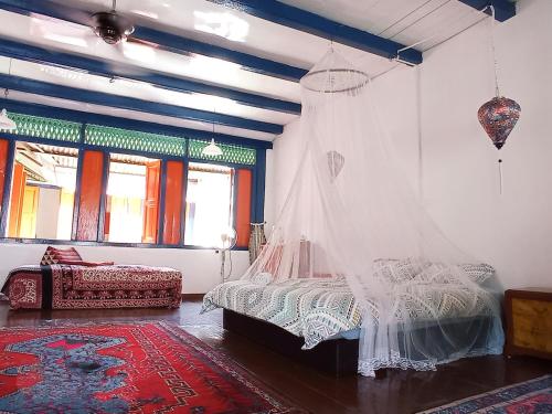 a bedroom with a bed with a mosquito net at Joti's oasis Chinatown in Melaka