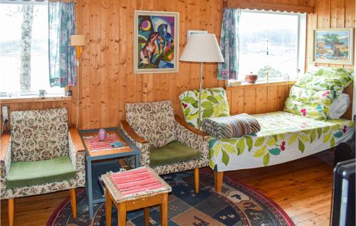 3 Bedroom Nice Home In Hyggen في Hyggen: غرفة معيشة مع كرسيين وأريكة