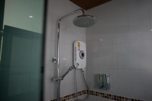 a shower in a bathroom with a shower head at Srichada Hotel Khaolak - SHA Extra Plus in Khao Lak