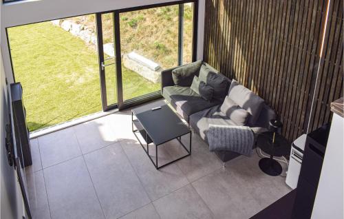 a living room with a couch and a table at Nice Home In Brevik With Kitchen in Bjønnes