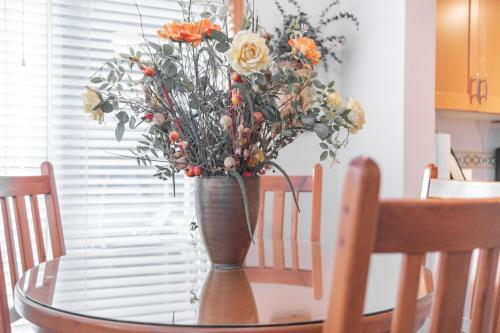 a vase with flowers sitting on a table at The best ski in ski out two bedroom condo at Aspens in Whistler