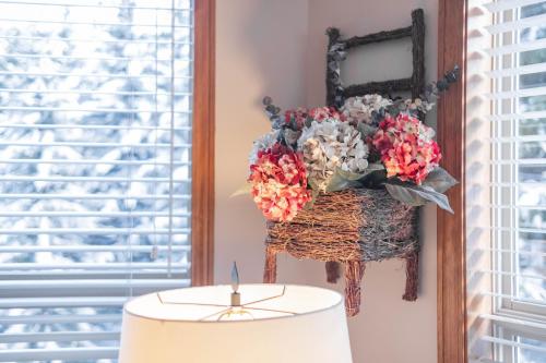 a table with a candle and a basket of flowers at The best ski in ski out two bedroom condo at Aspens in Whistler