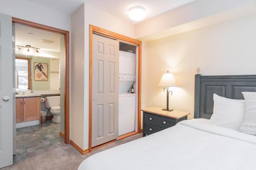 a bedroom with a bed and a bathroom at The best ski in ski out two bedroom condo at Aspens in Whistler